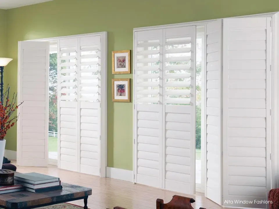 Alta bifold shutters on a sliding glass door in a living room