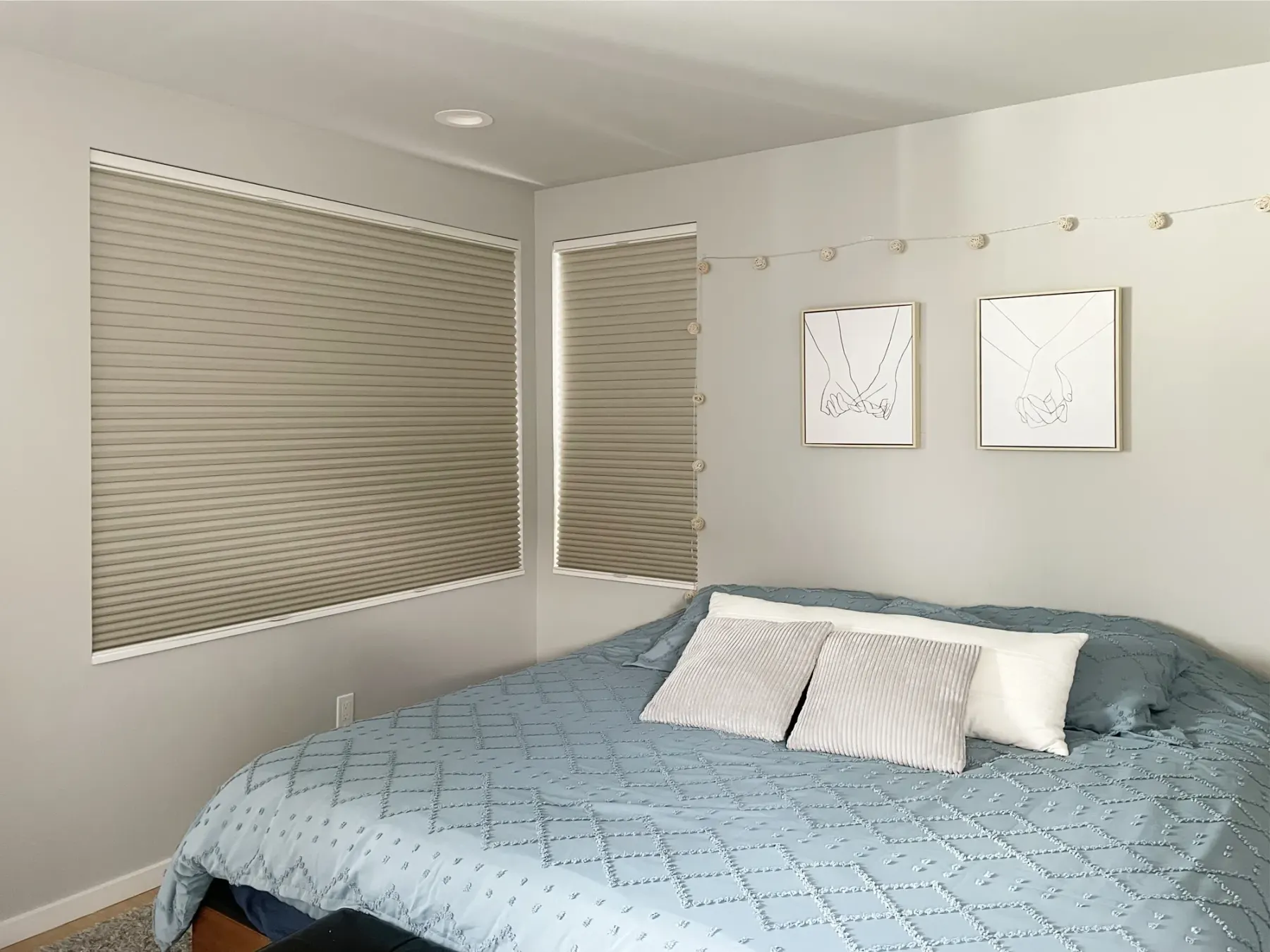 Blackout honeycomb shades showing light leak at the edges in a Seattle bedroom