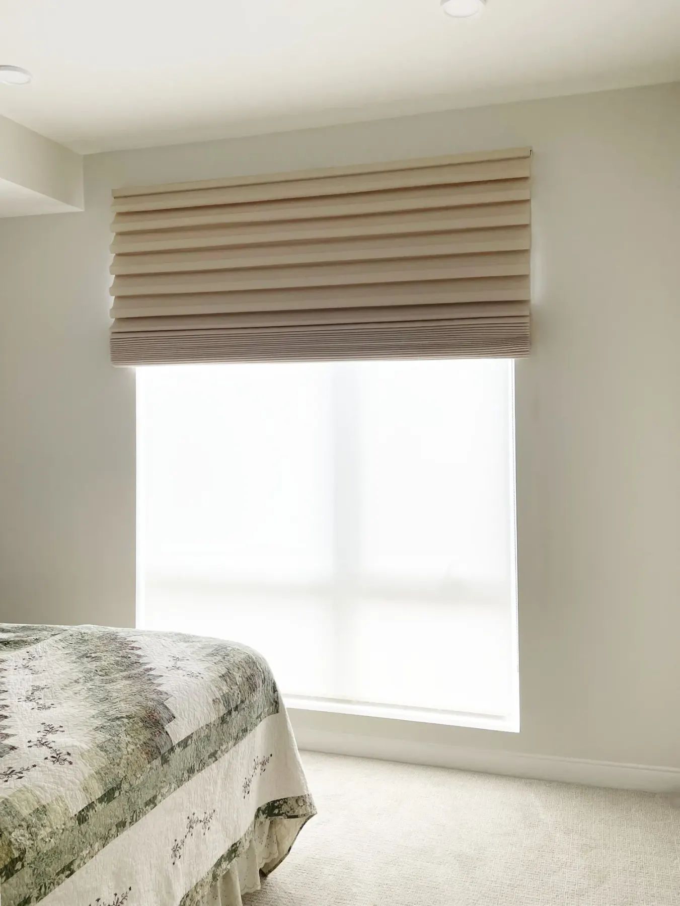 Blackout Roman shades in front of solar shades installed in a Kirkland bedroom condo