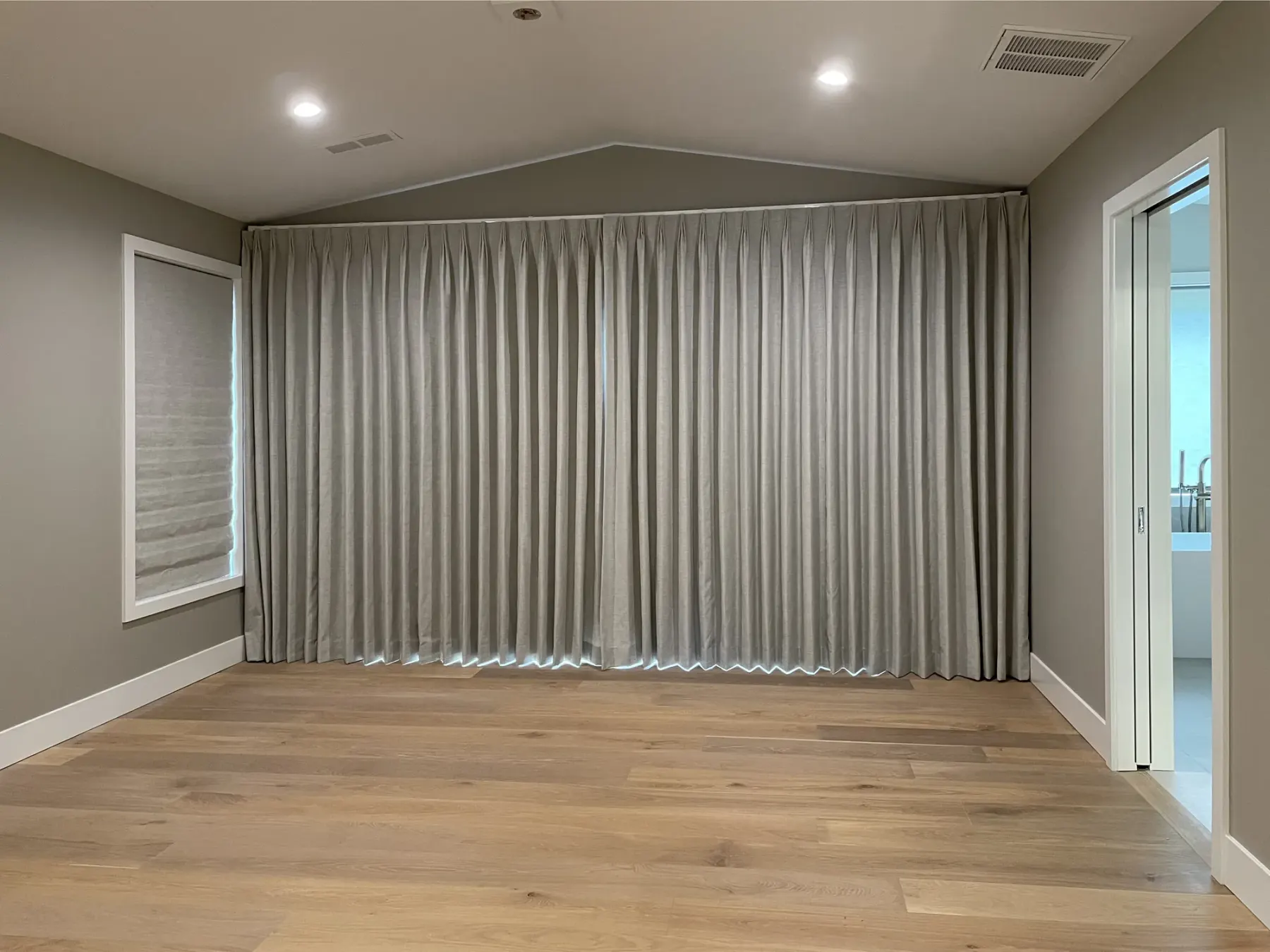 Custom drapery a sliding glass door in a Redmond primary bedroom