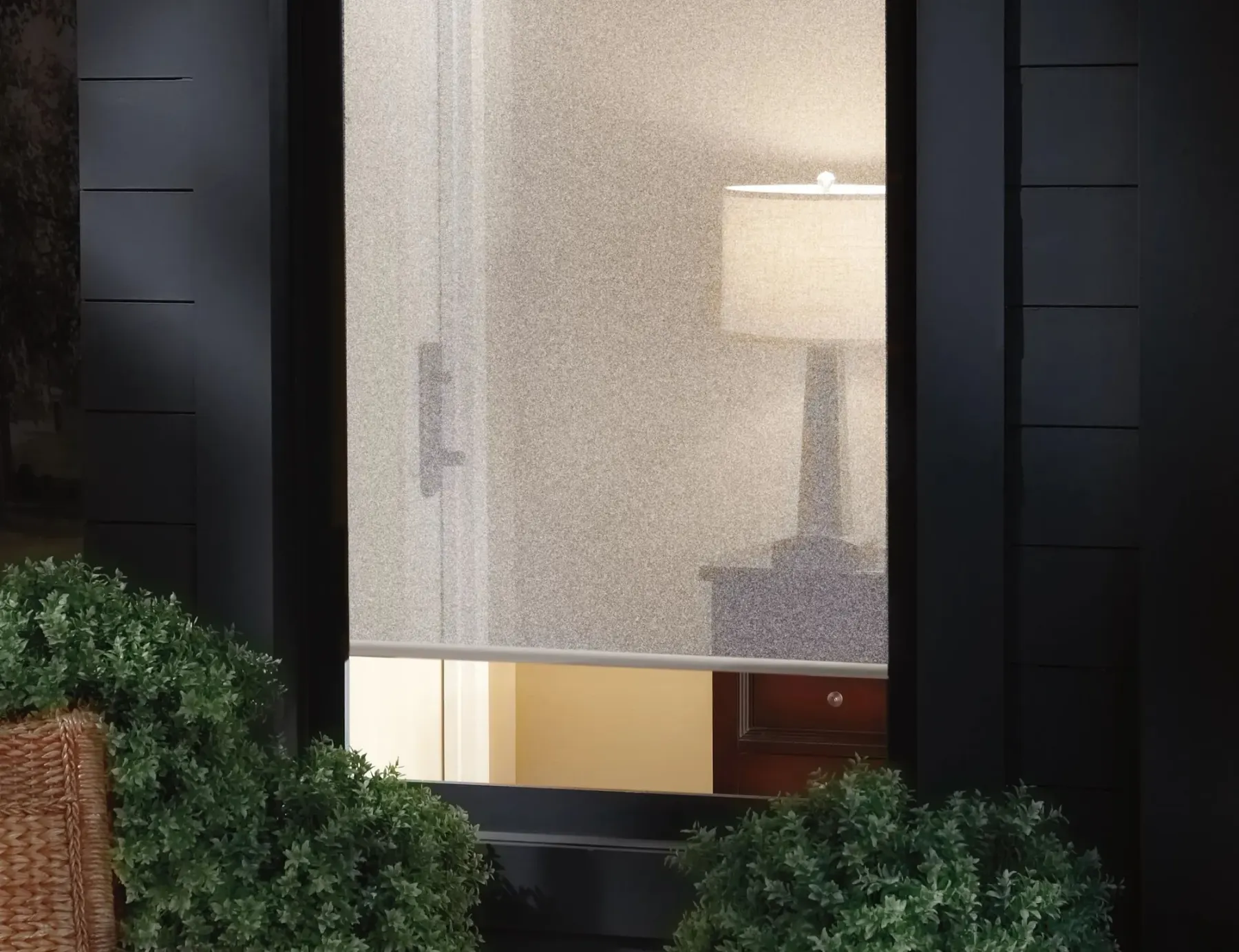 Hunter Douglas screen shades viewed from outside a home looking in