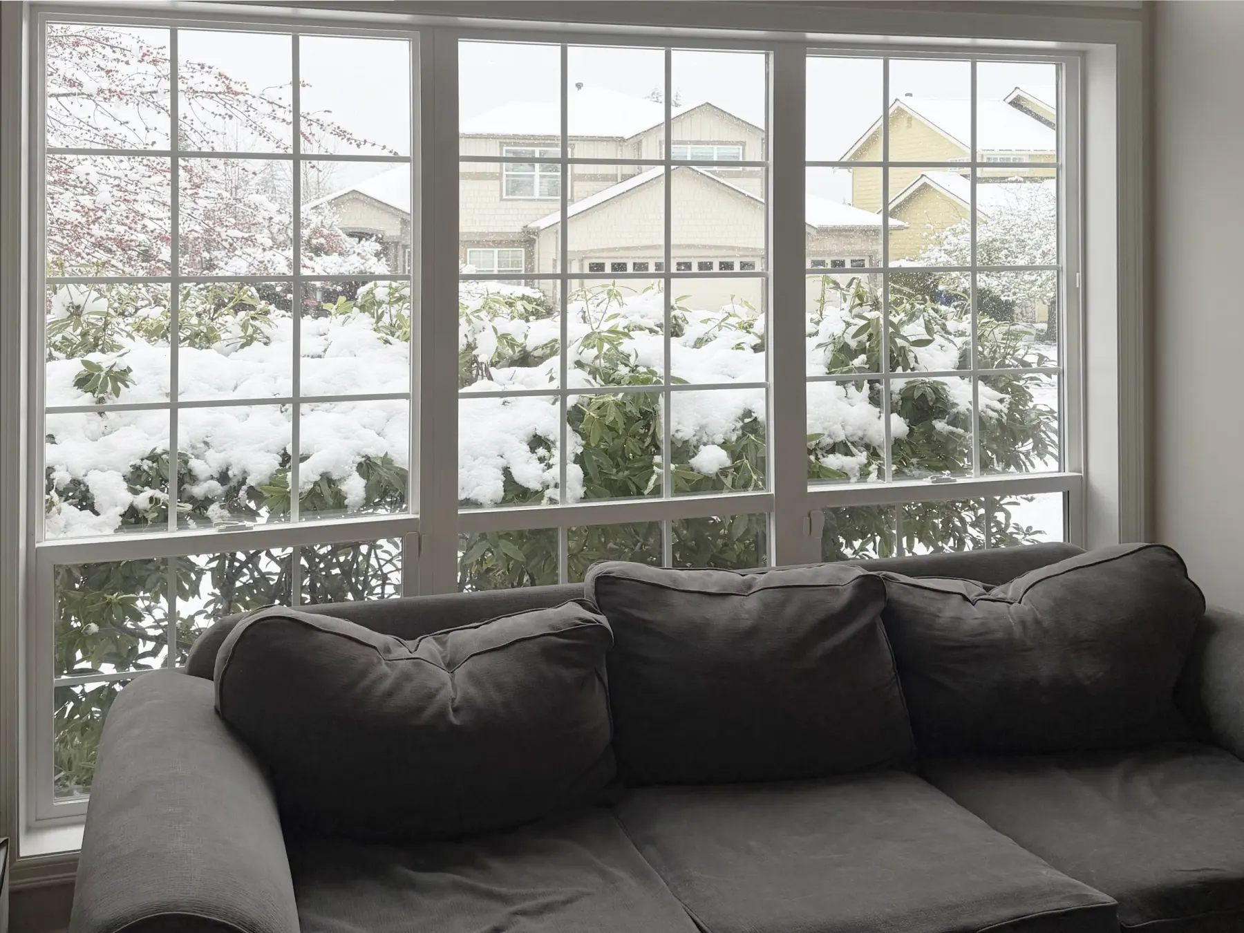 Large living room window needing energy efficient window coverings during winter in a Sammamish home.