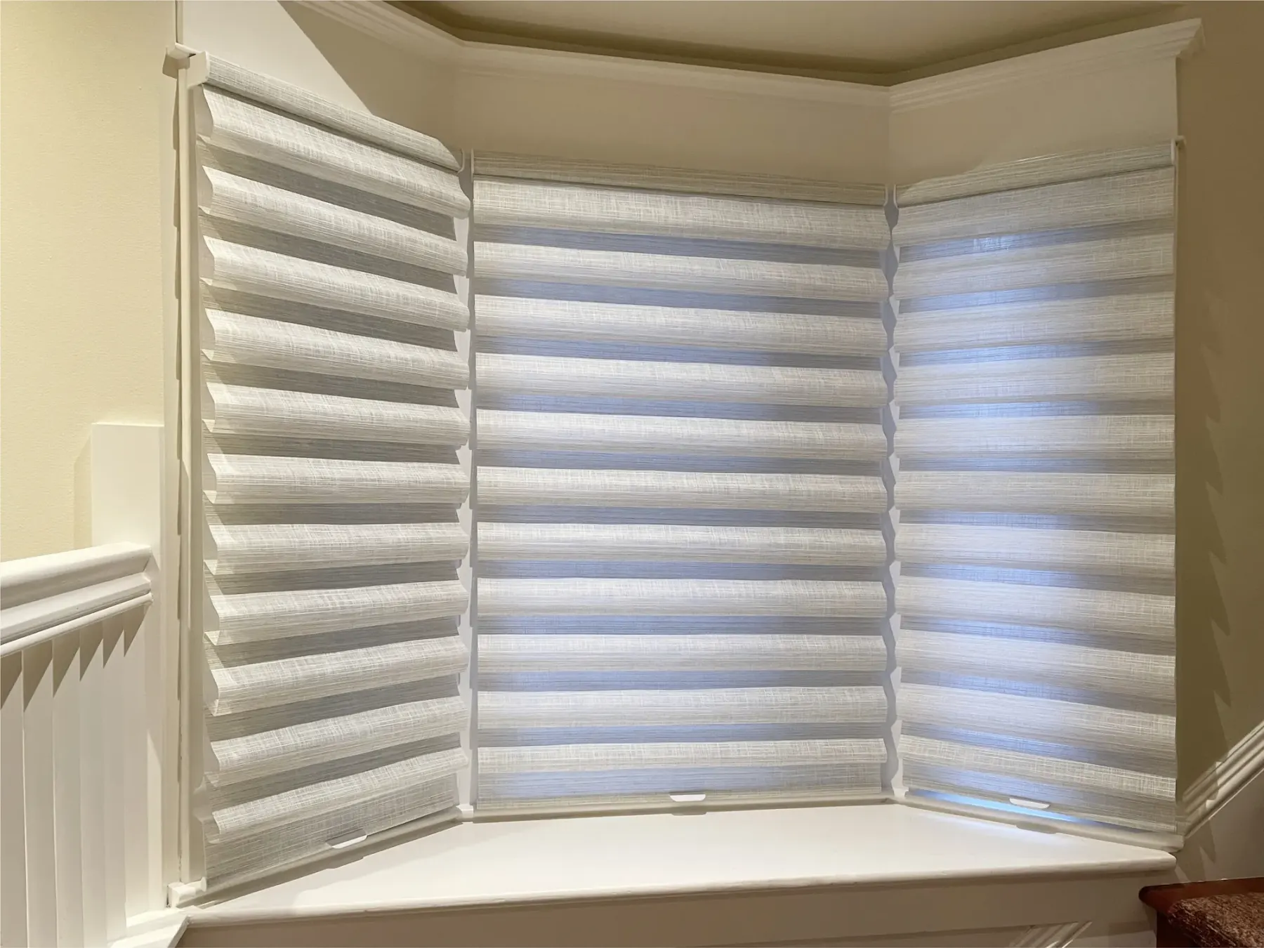 Lined roman shades installed on a bay window in a Seattle home