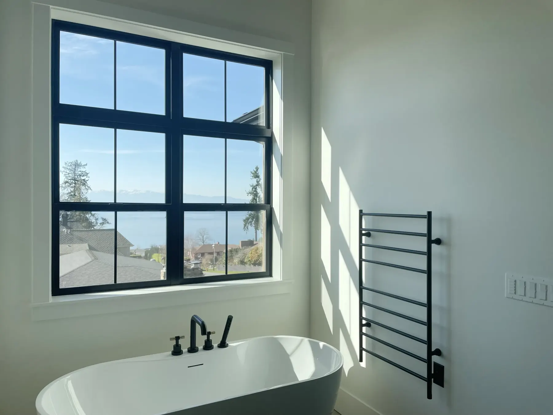 Primary bathroom window before new shades are installed in a Shoreline home