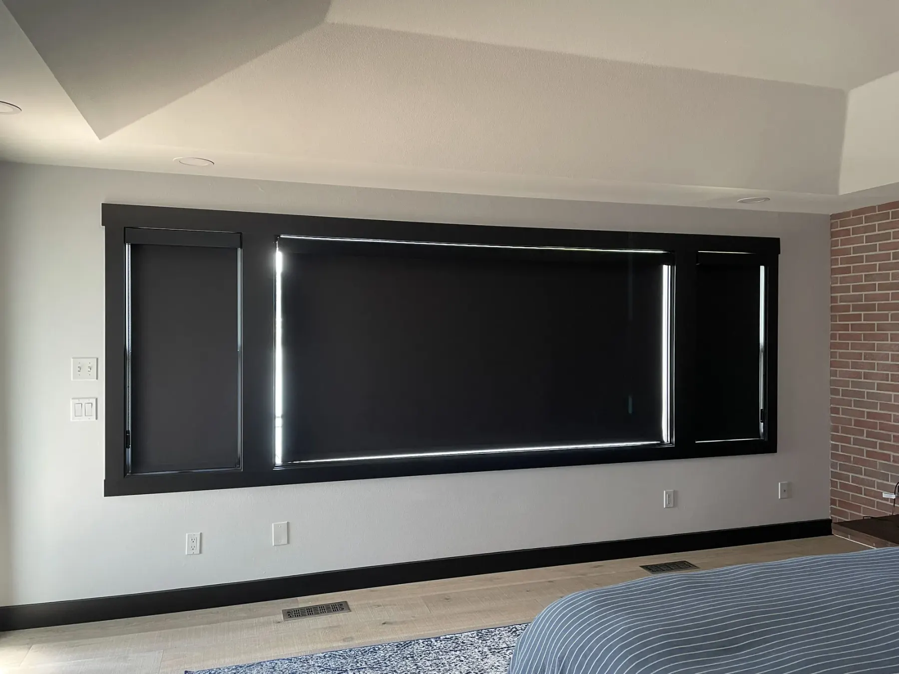 Motorized blackout roller shades on west-facing bedroom windows overlooking Lake Washington in Bellevue.