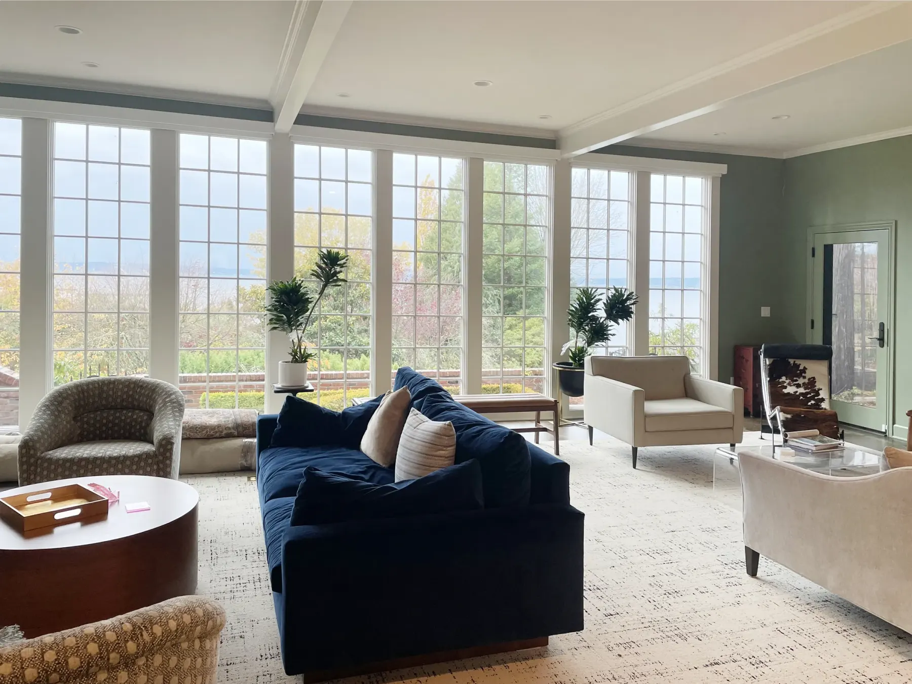 Motorized roller shades raised on large windows in a Seattle living room