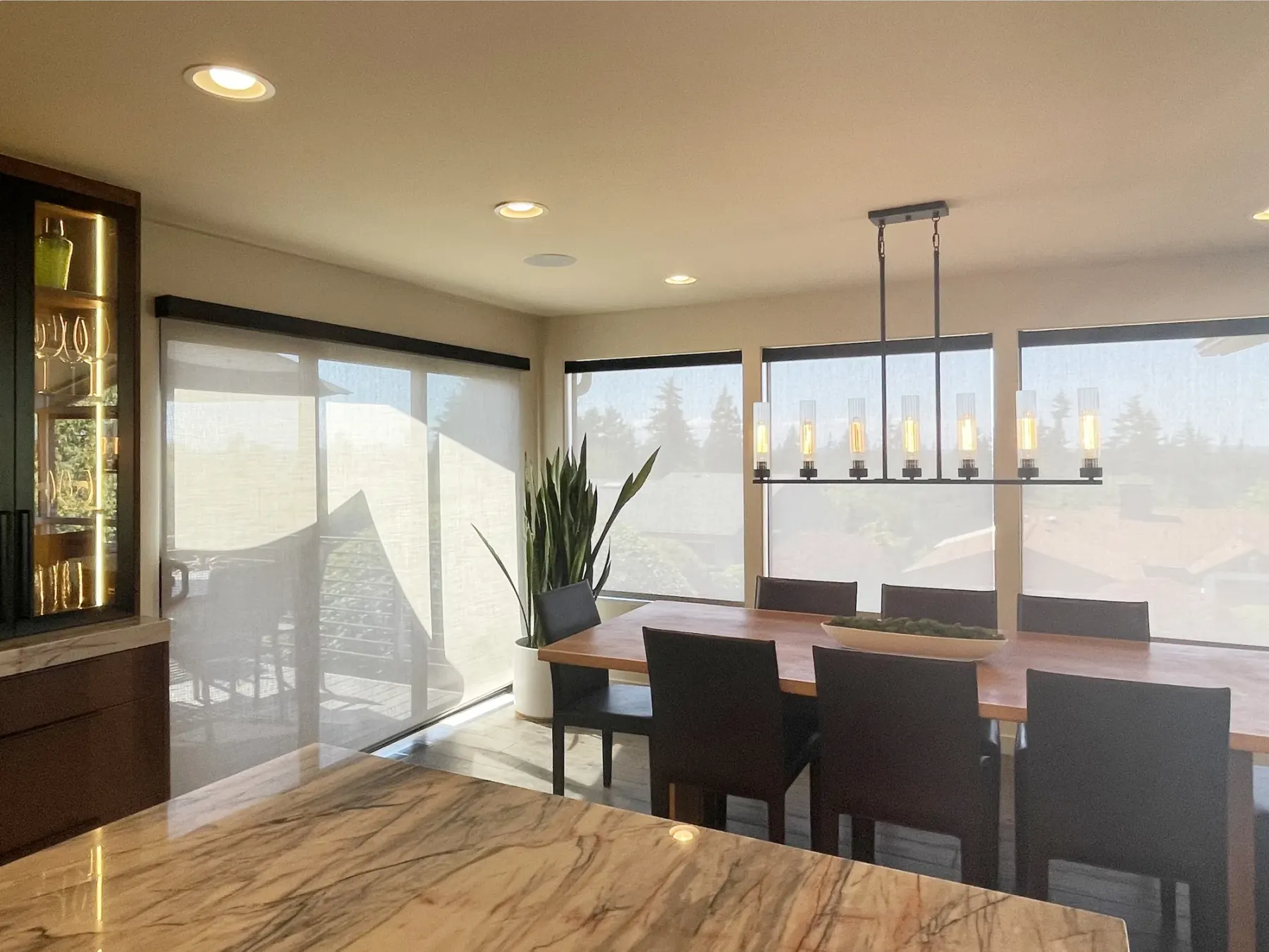 Motorized solar screen shades on a sliding glass door in a Bellevue dining room