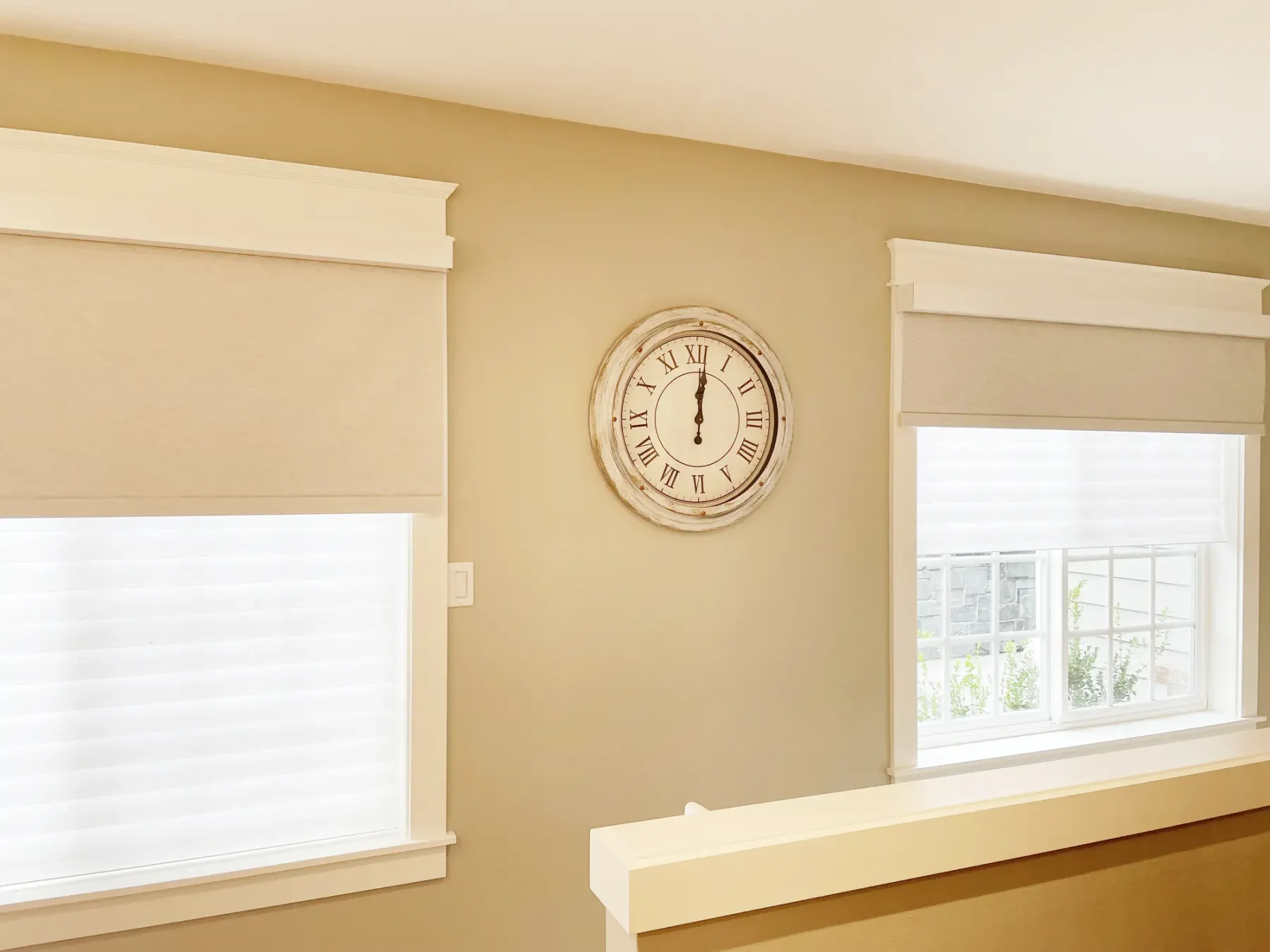 Motorized blackout roller shades layered in front of Silhouette® sheer shades in a Woodinville stairway