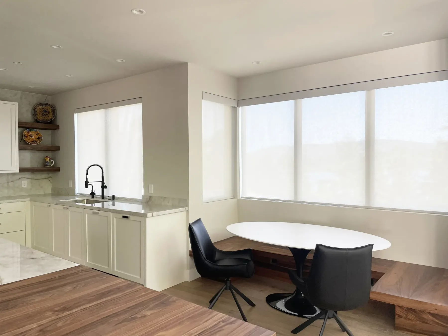 Motorized solar shades installed in a Mercer Island home to reduce glare and protect interiors from UV damage while preserving view