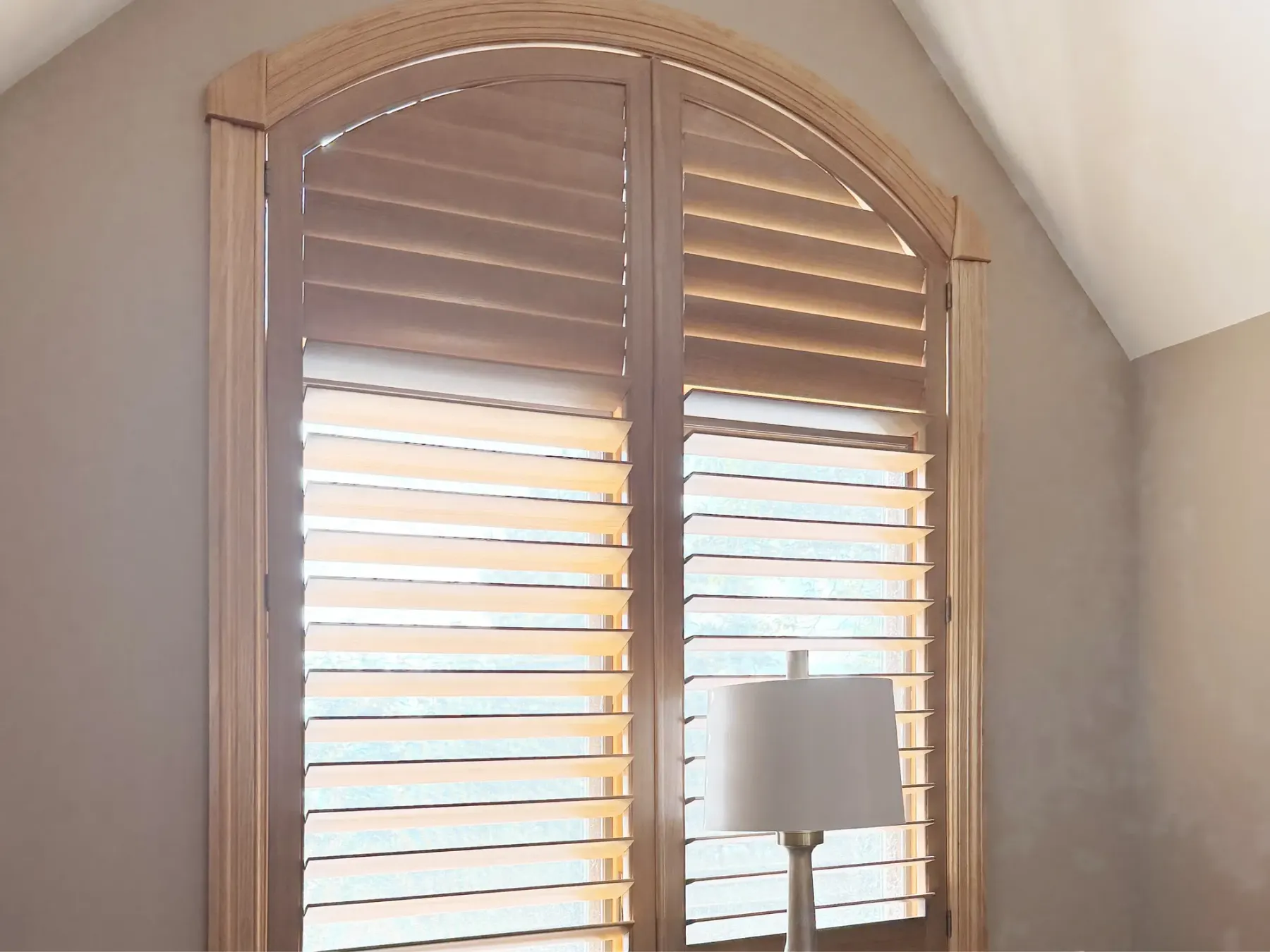 Plantation shutters on an arched window