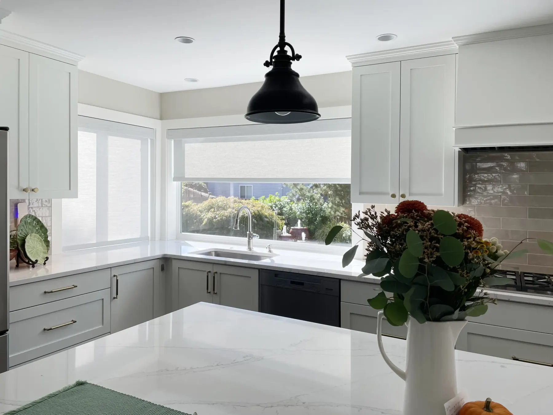 Flowers on kitchen counter with solar shades in Brier kitchen