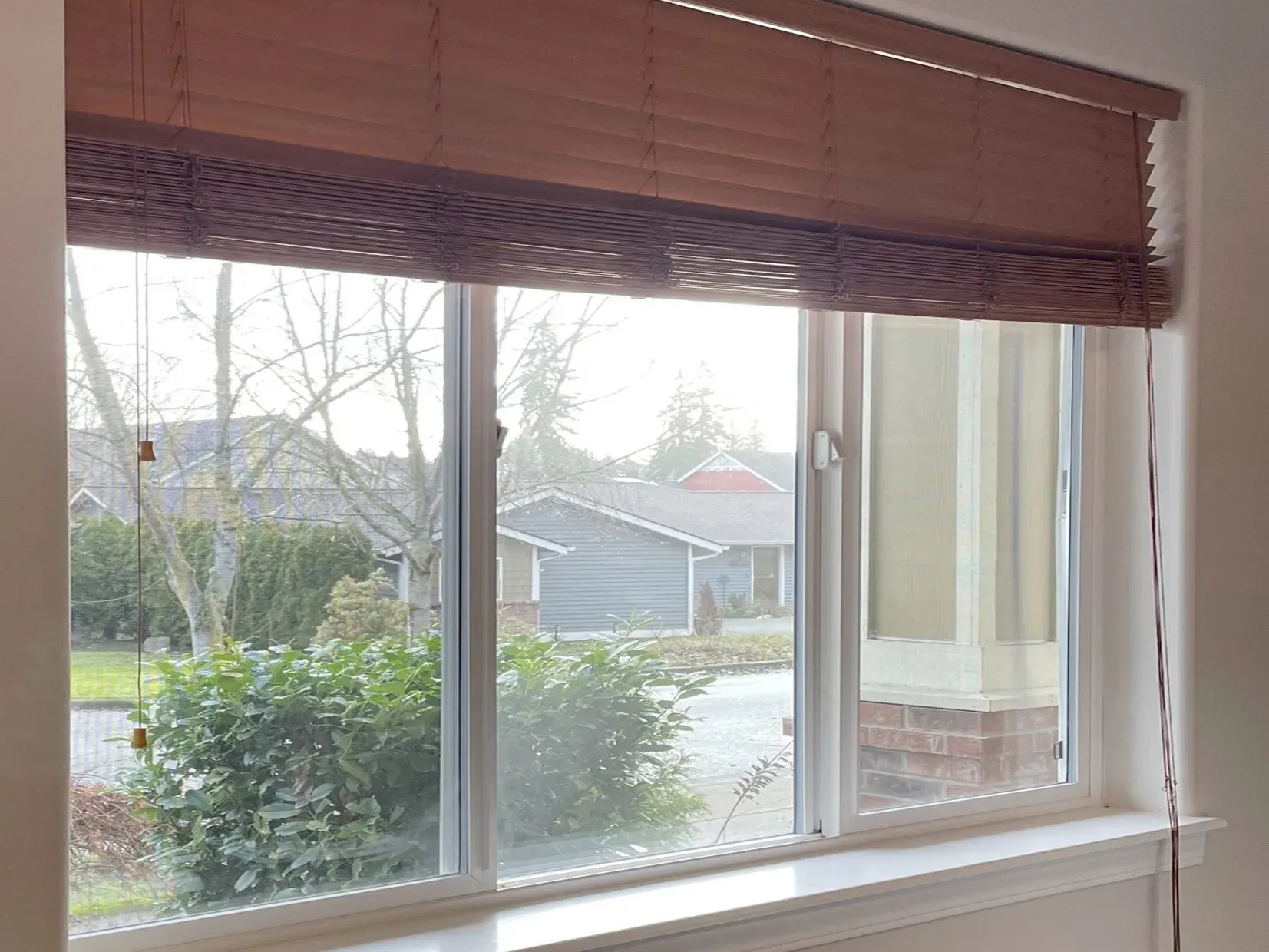Wood blinds with long hanging cords in a home office in Duvall, WA