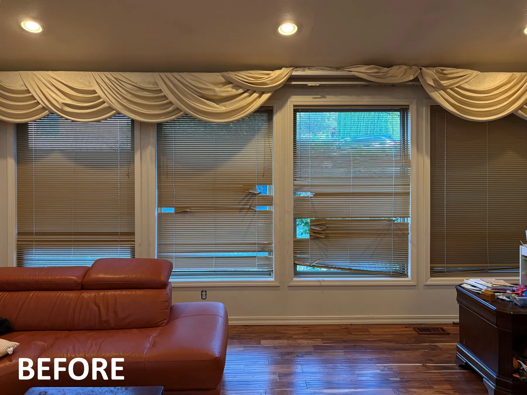 Broken blinds and swags before it was replaced with roller shades for a living room in Bellevue