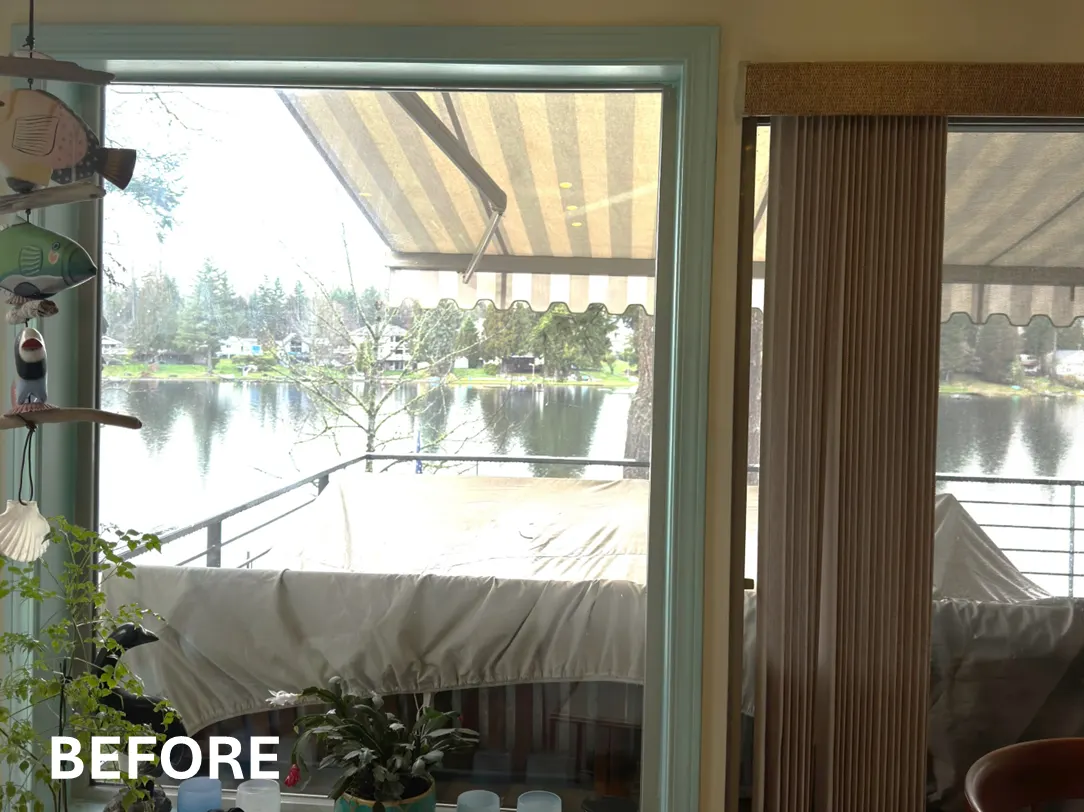 Vertical blinds in a sliding glass door before replacing with roman shades