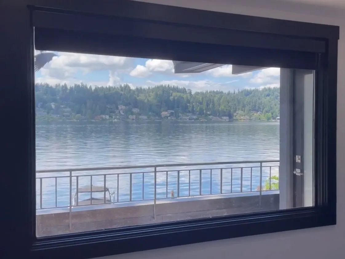 Motorized Roller Shades in a Raised Position for a Waterfront Bedroom in Bellevue