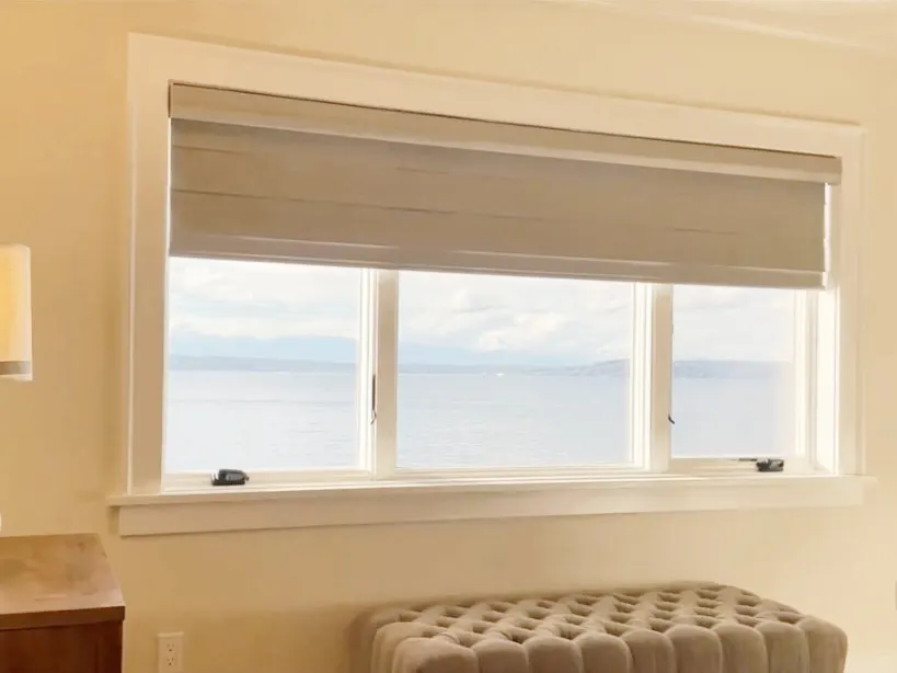 Motorized Pirouette Sheer Shades Partially Raised for a Primary Bedroom in a Shoreline Waterfront Home